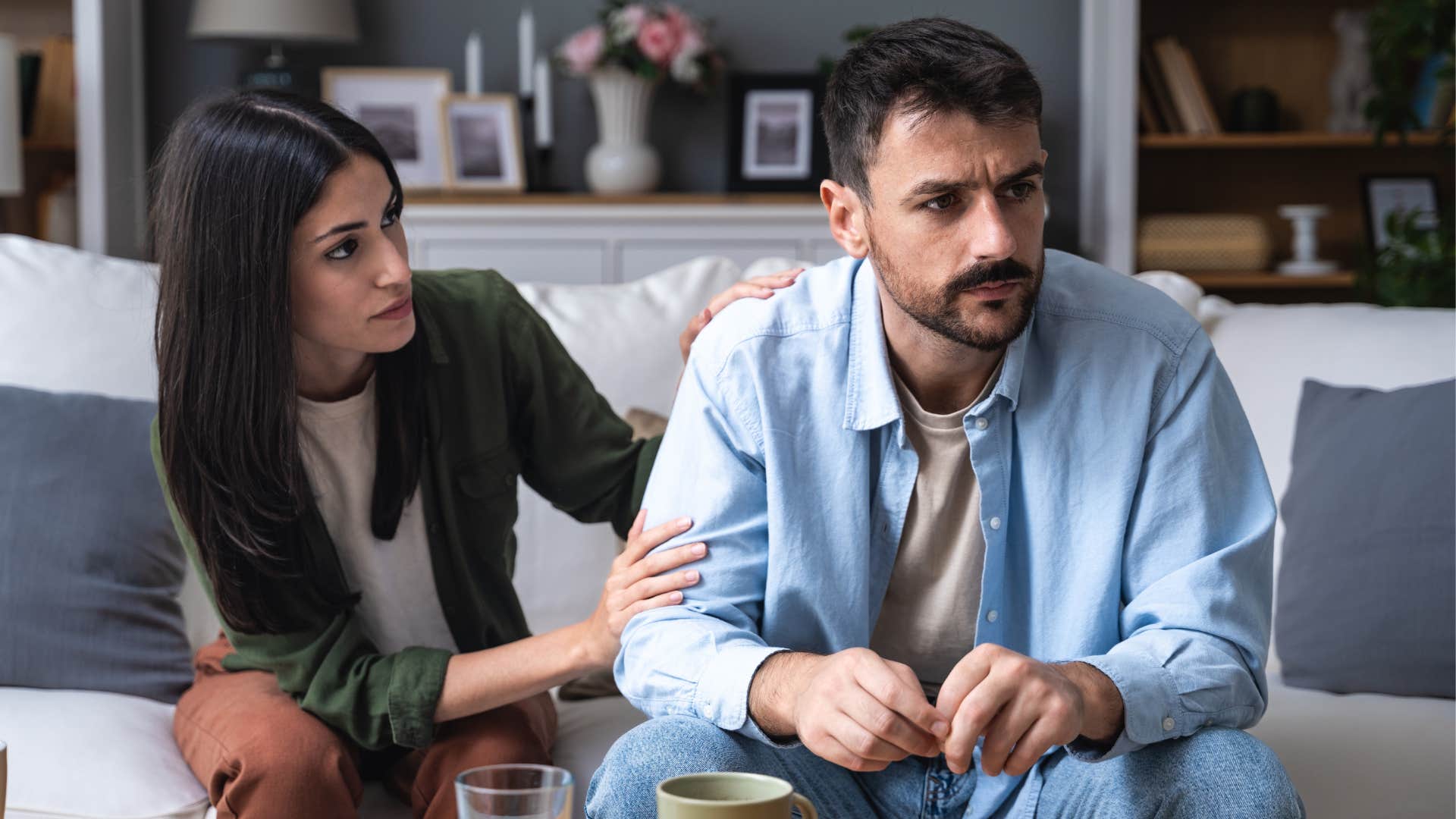 man avoiding vulnerability turned away from his partner