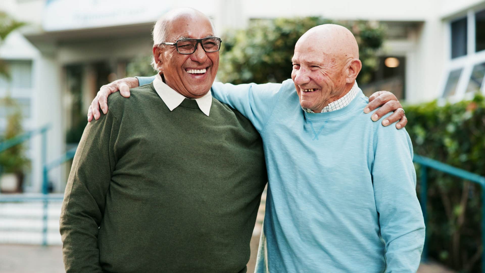 man who uses humor to cope hugging his friend