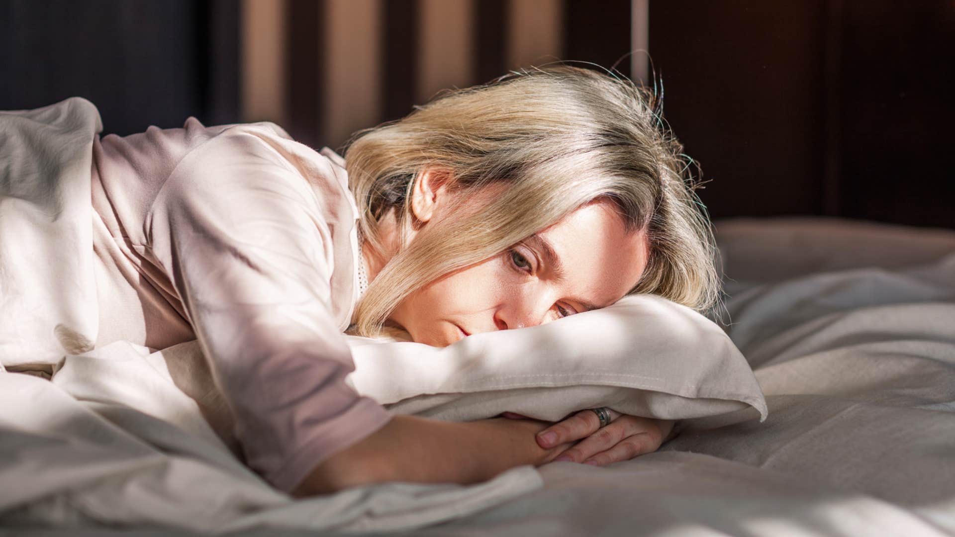 woman who isolates herself laying in bed