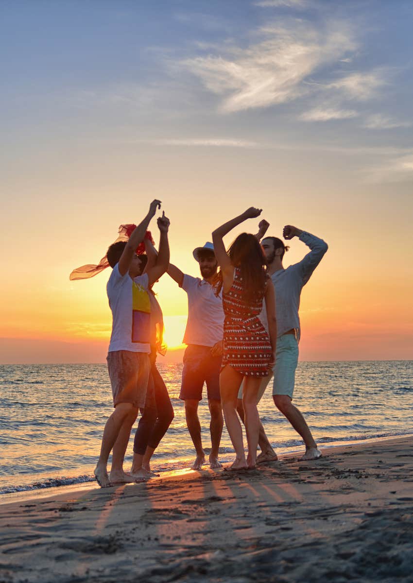 tourists dancing to loud music on beach