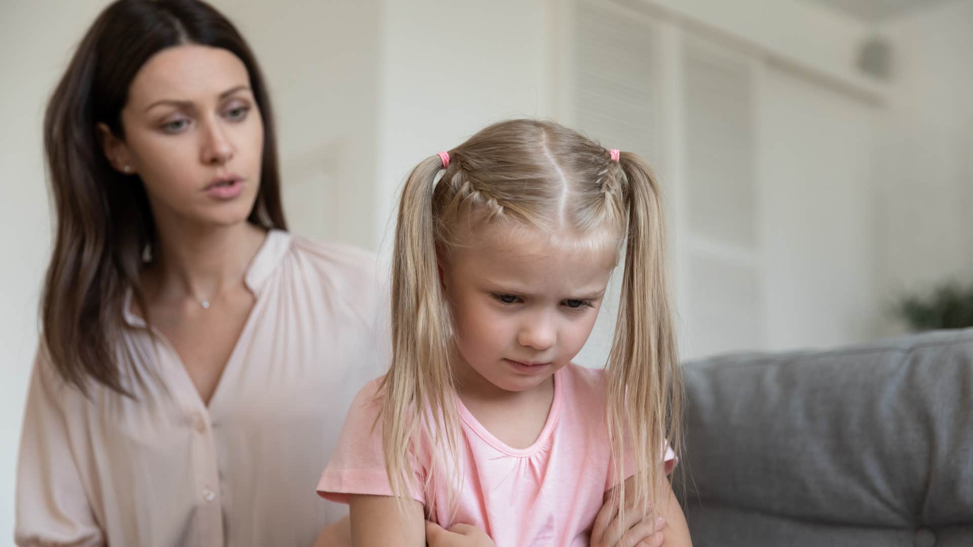 mom scolding little girl after she acted out