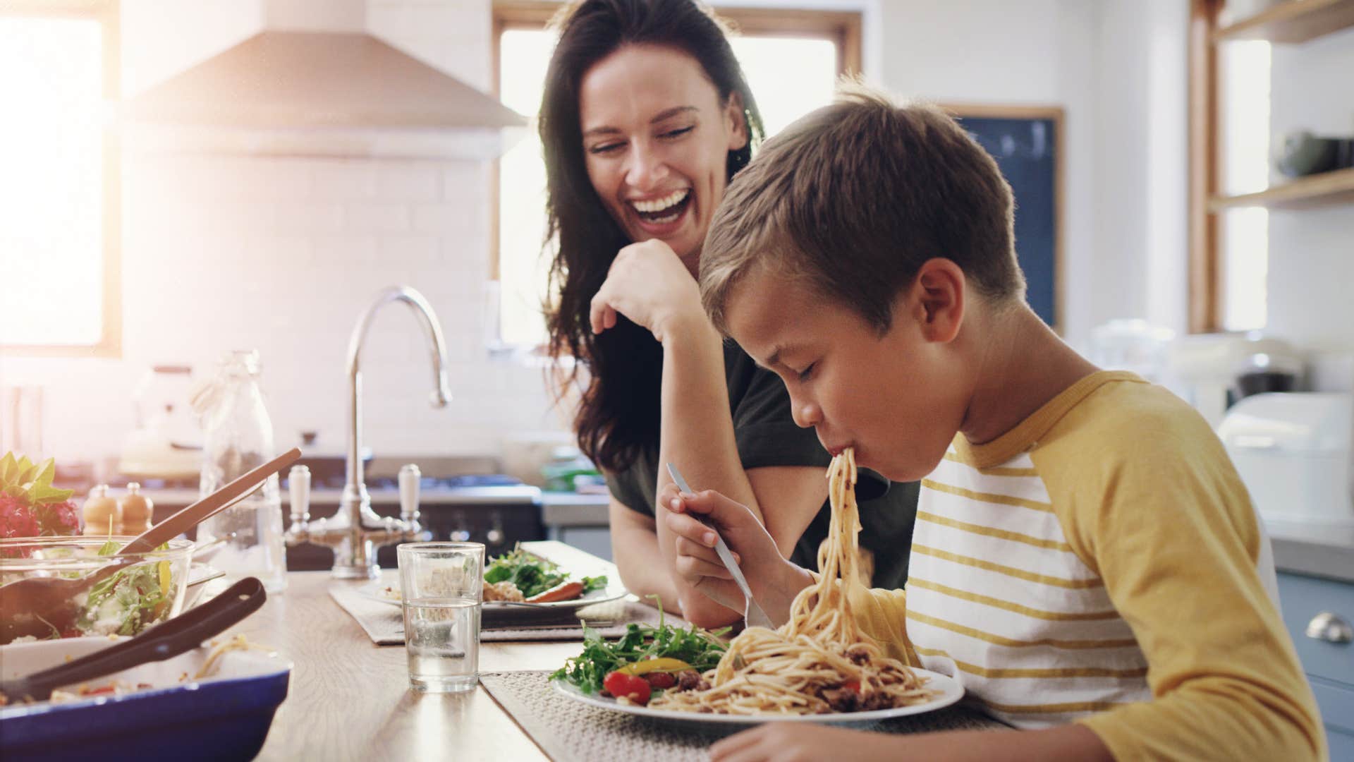 kid eating spaghetti with poor manners