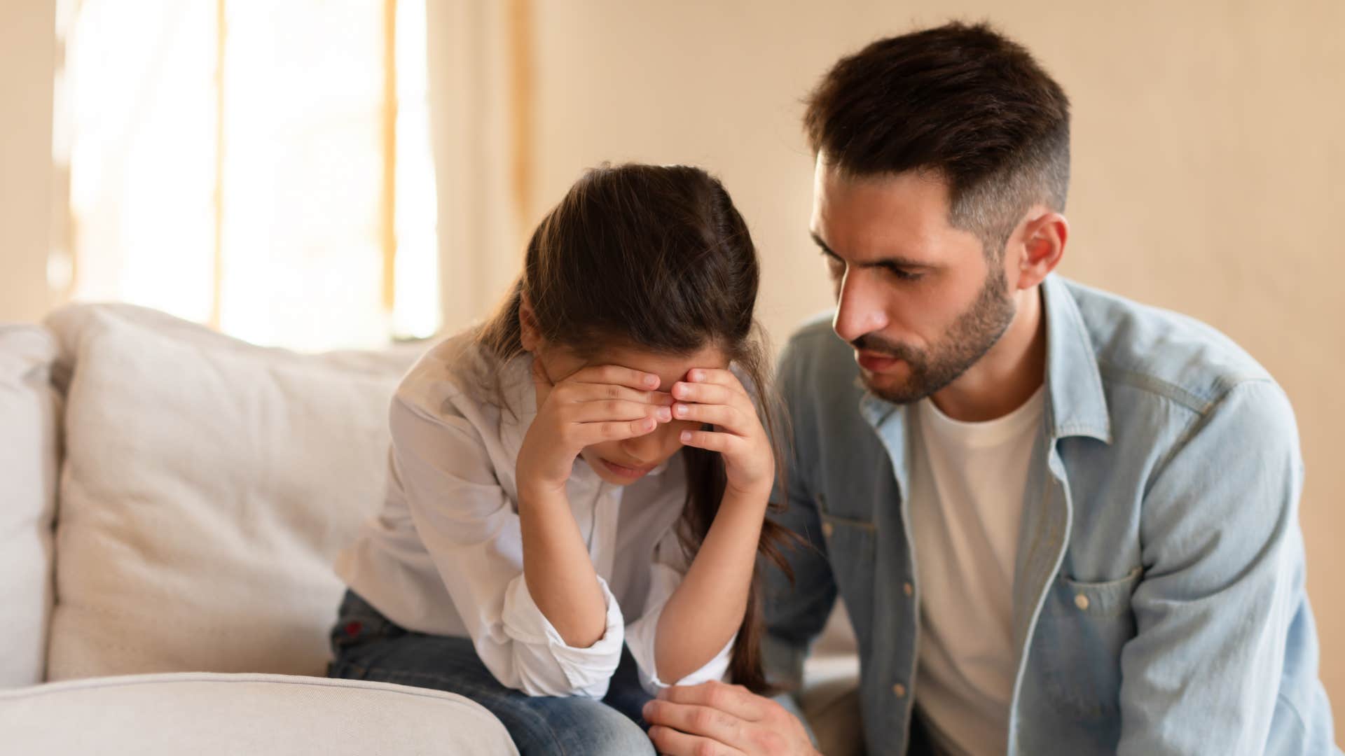 father disciplining young daughter after she was disrespectful
