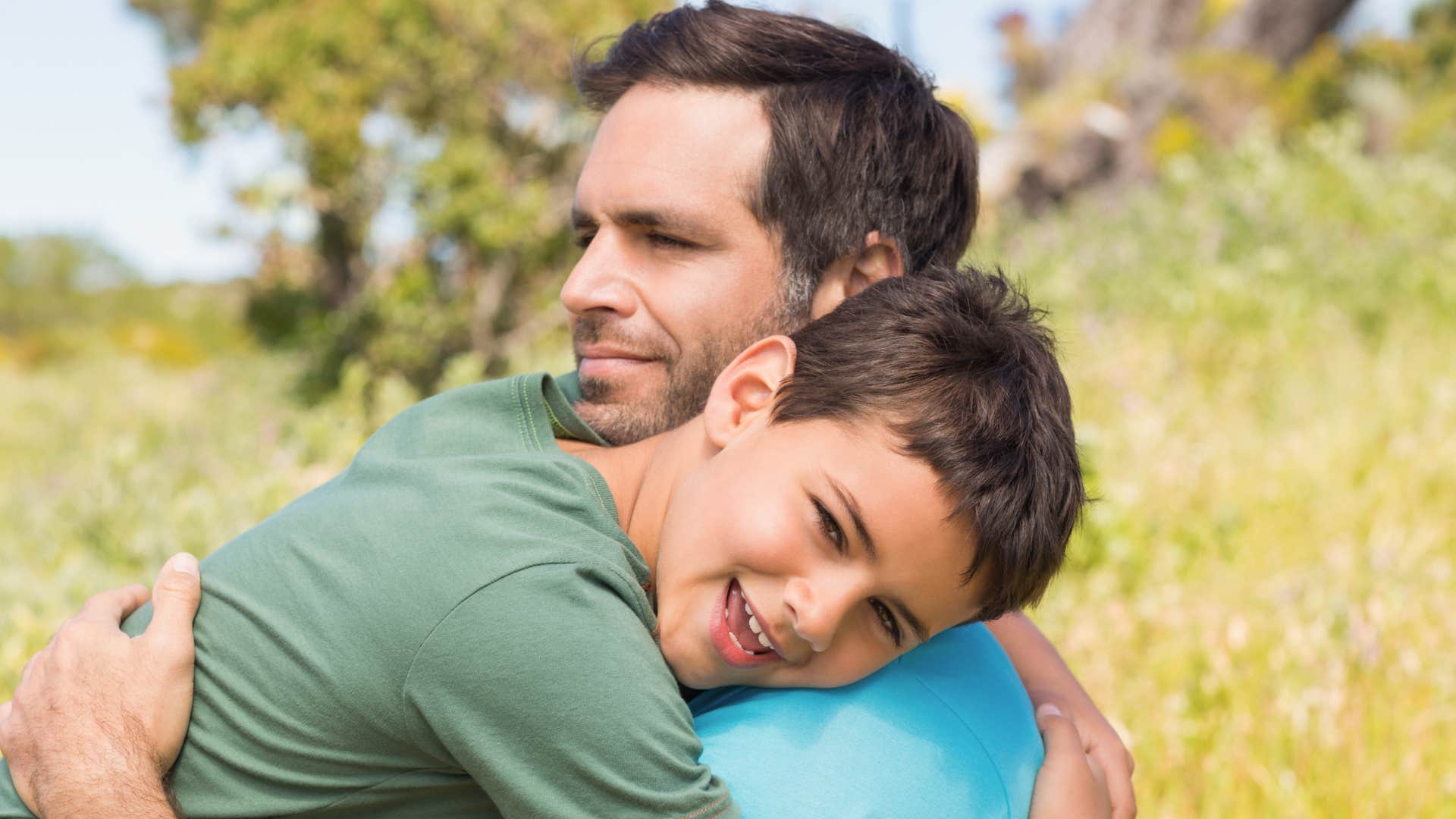young boy hugging his dad with gratitude