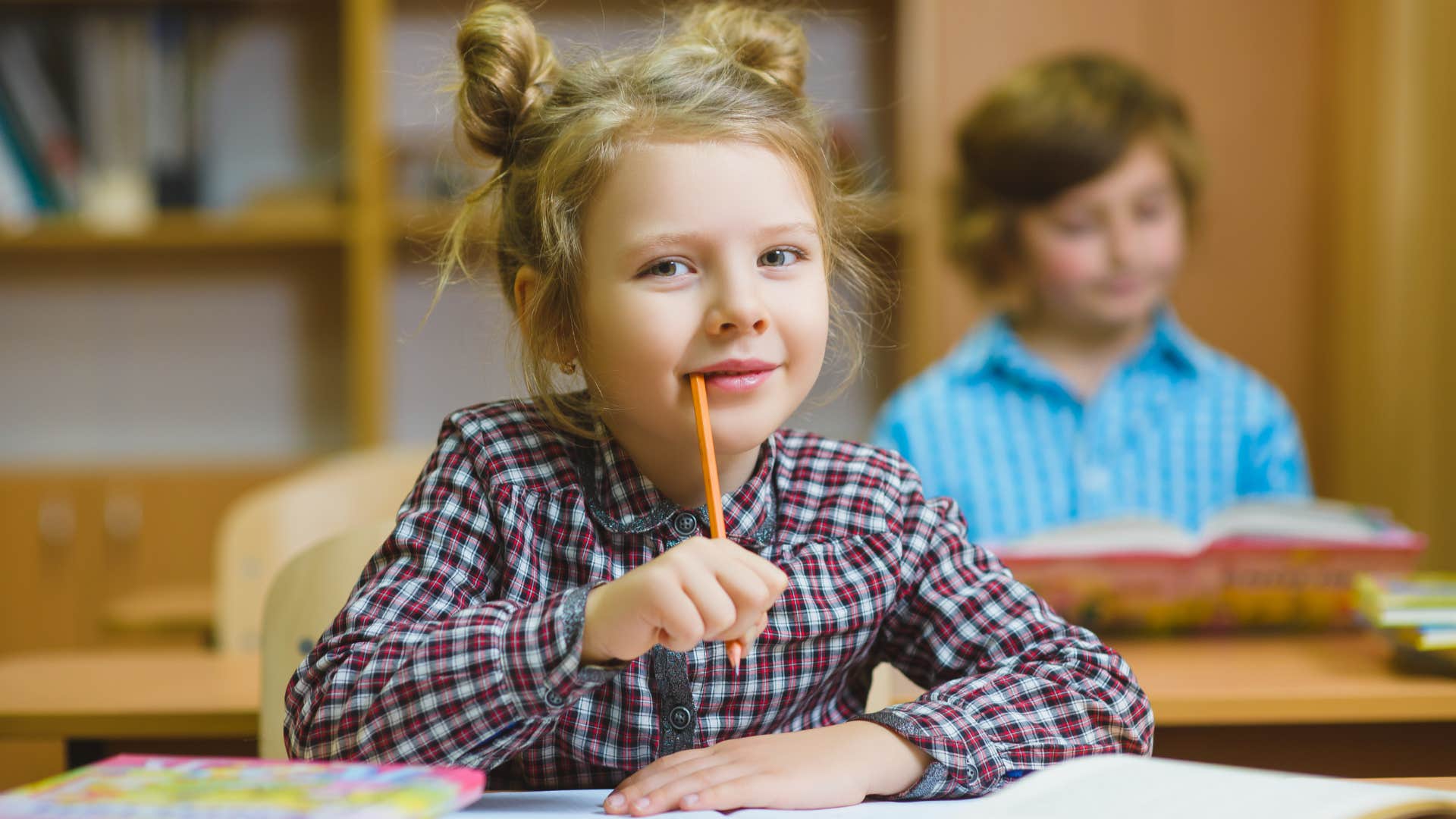 young girl studying hard in school