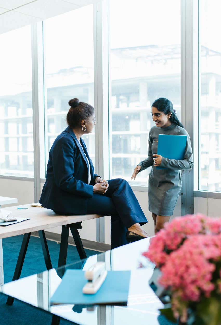 Compassionate boss talking to employees shows effective leadership