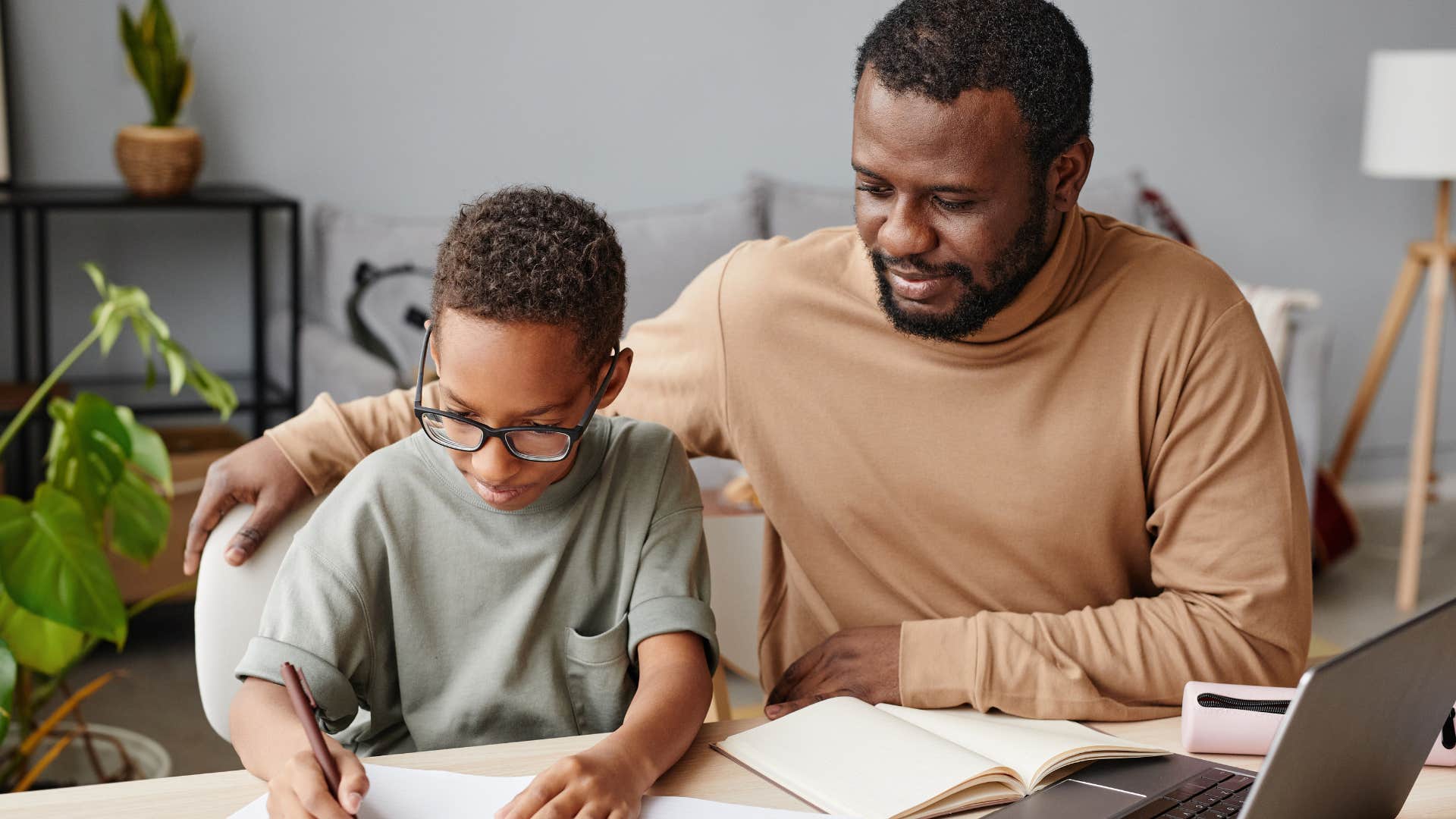 man teaching his young son about hard work