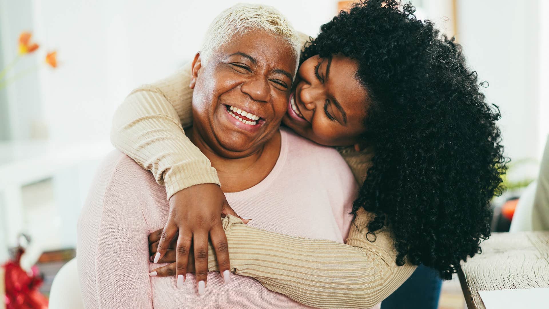 woman supporting herself and hugging her mother