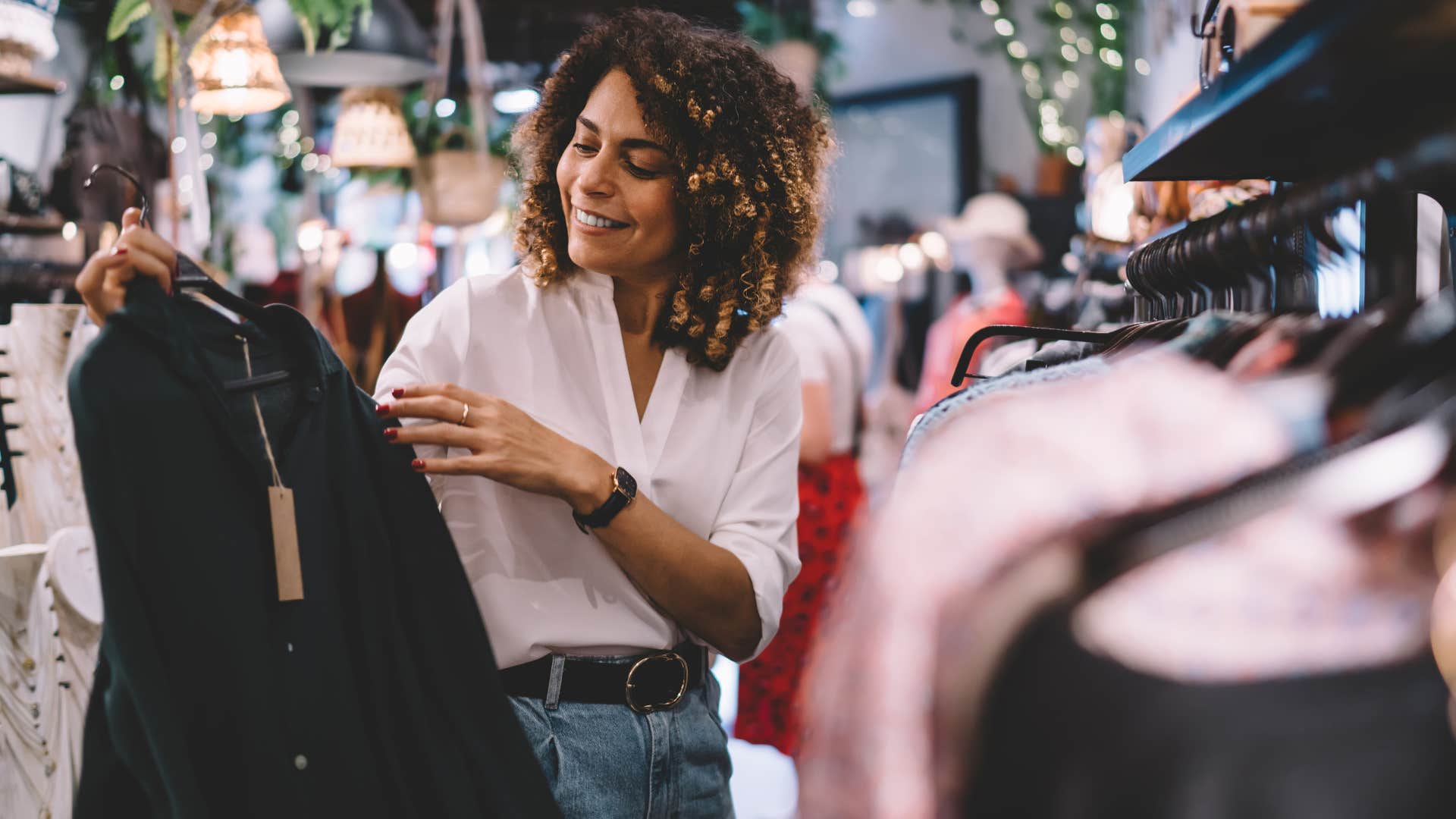 woman buying used clothes at a thrift store