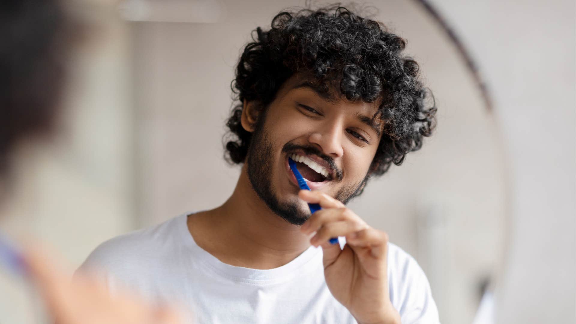 a man brushes his teeth after not doing it for days