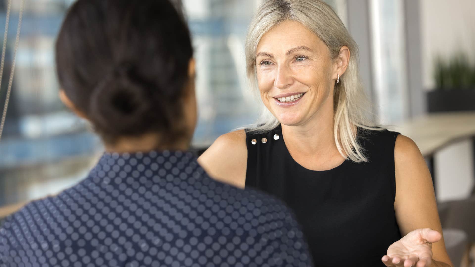 woman telling her co-worker she's not sure about something