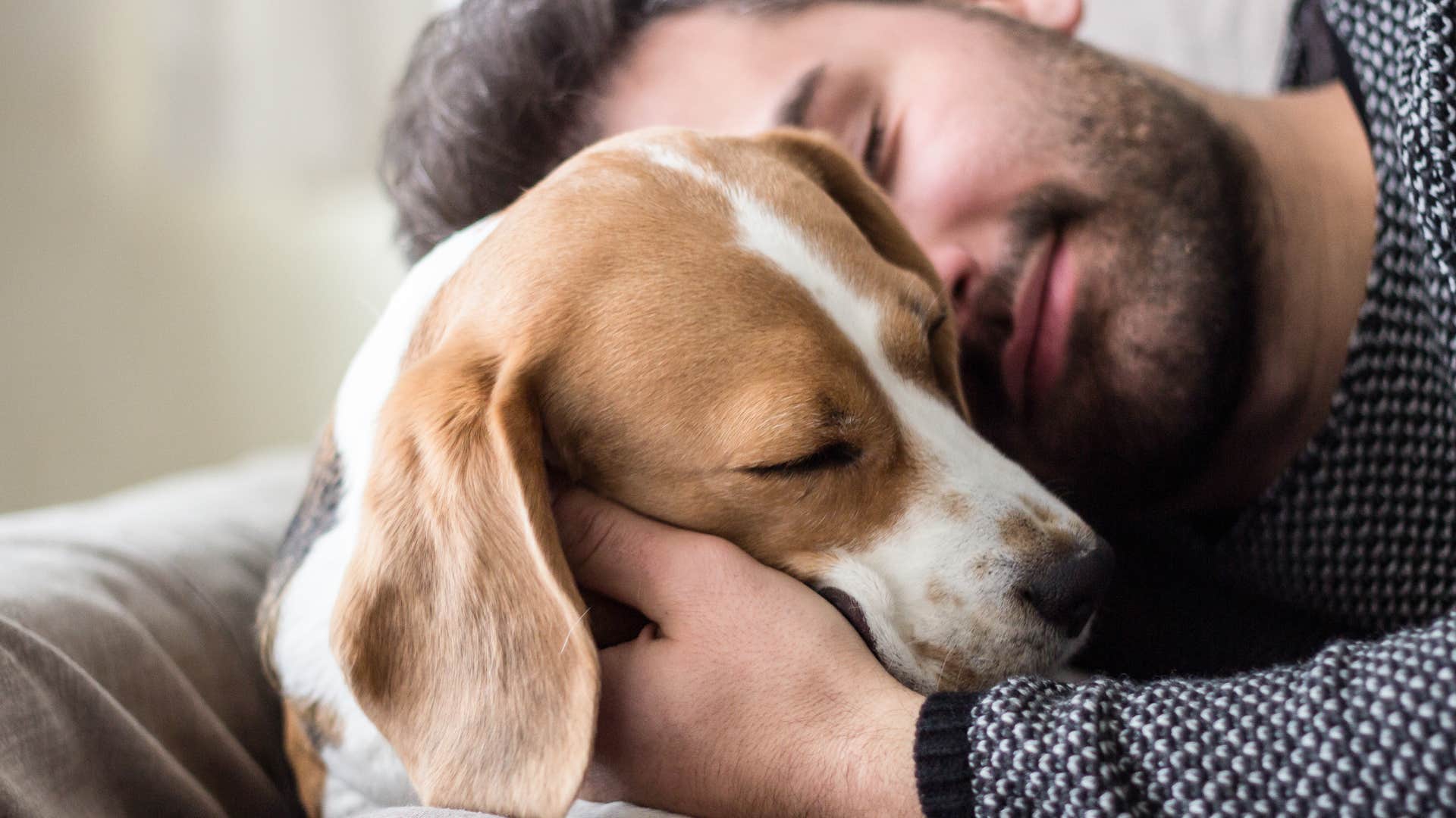 Man hugging his dog who misses them when you're apart. 