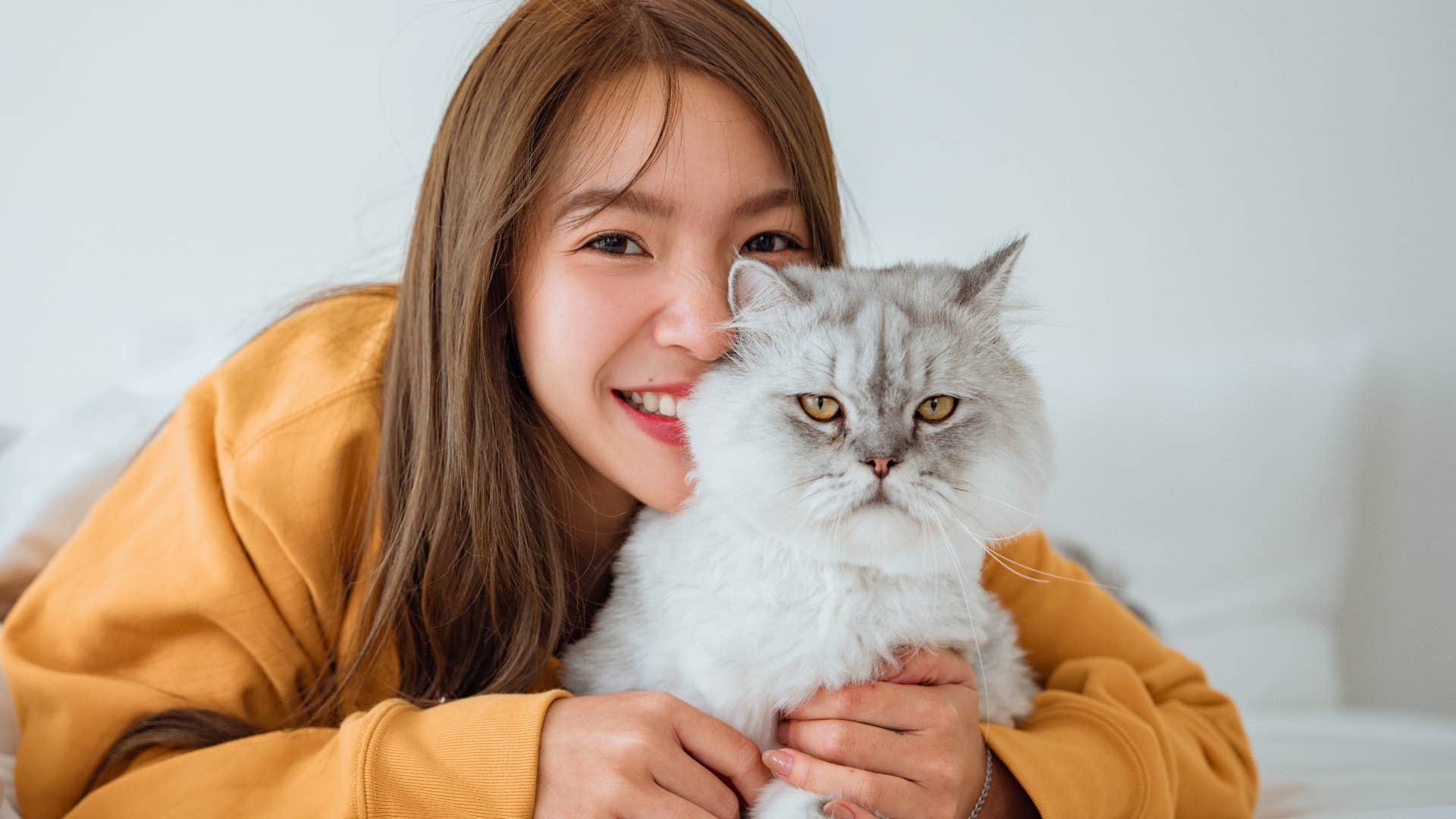 Woman who knows quality time feels healing hugging her cat.