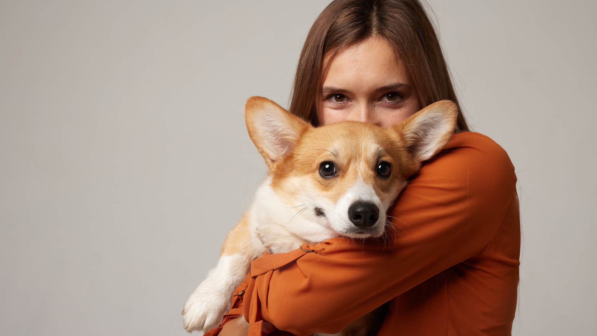 Woman hugging her dog who can sense when you're not feeling well.