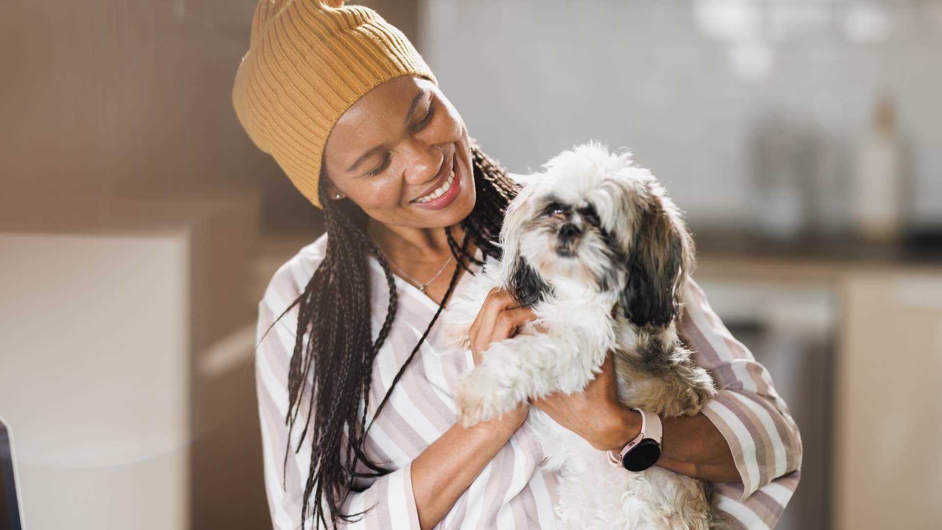 Woman who believes her pets are teachers hugging her dog.