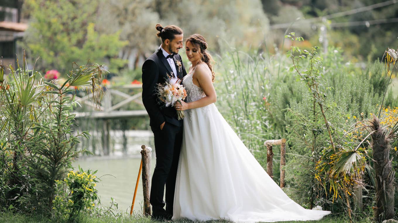 couple exchange silent vows while destination wedding guests sit in sun bride and groom