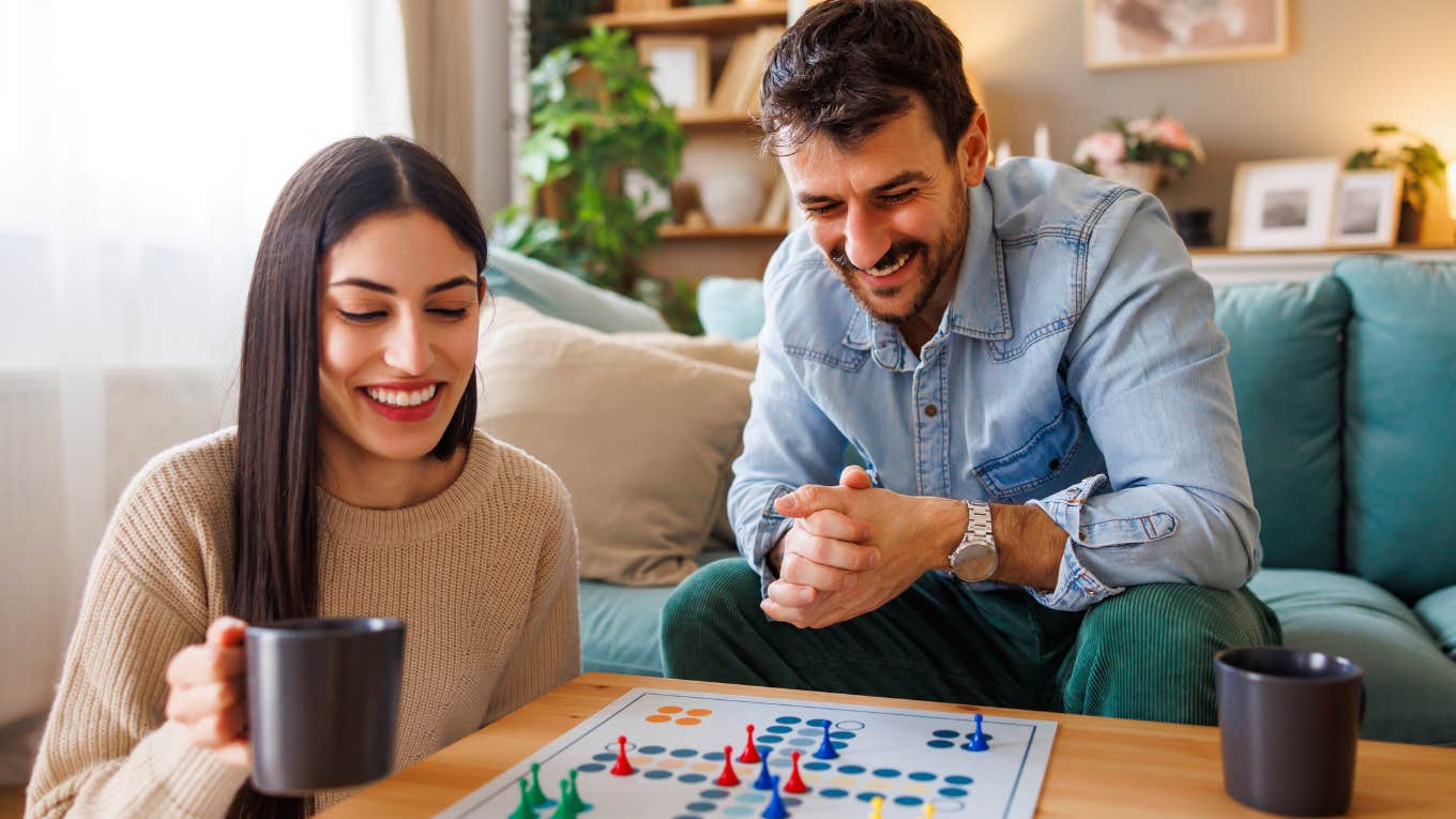 Happy couple playing a board game together.