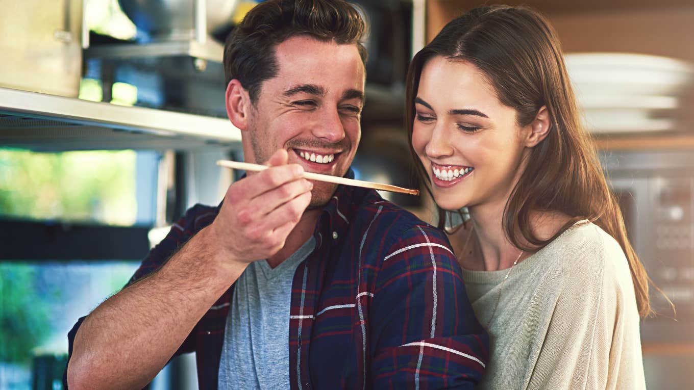 Happy couple cooking together in their kitchen.