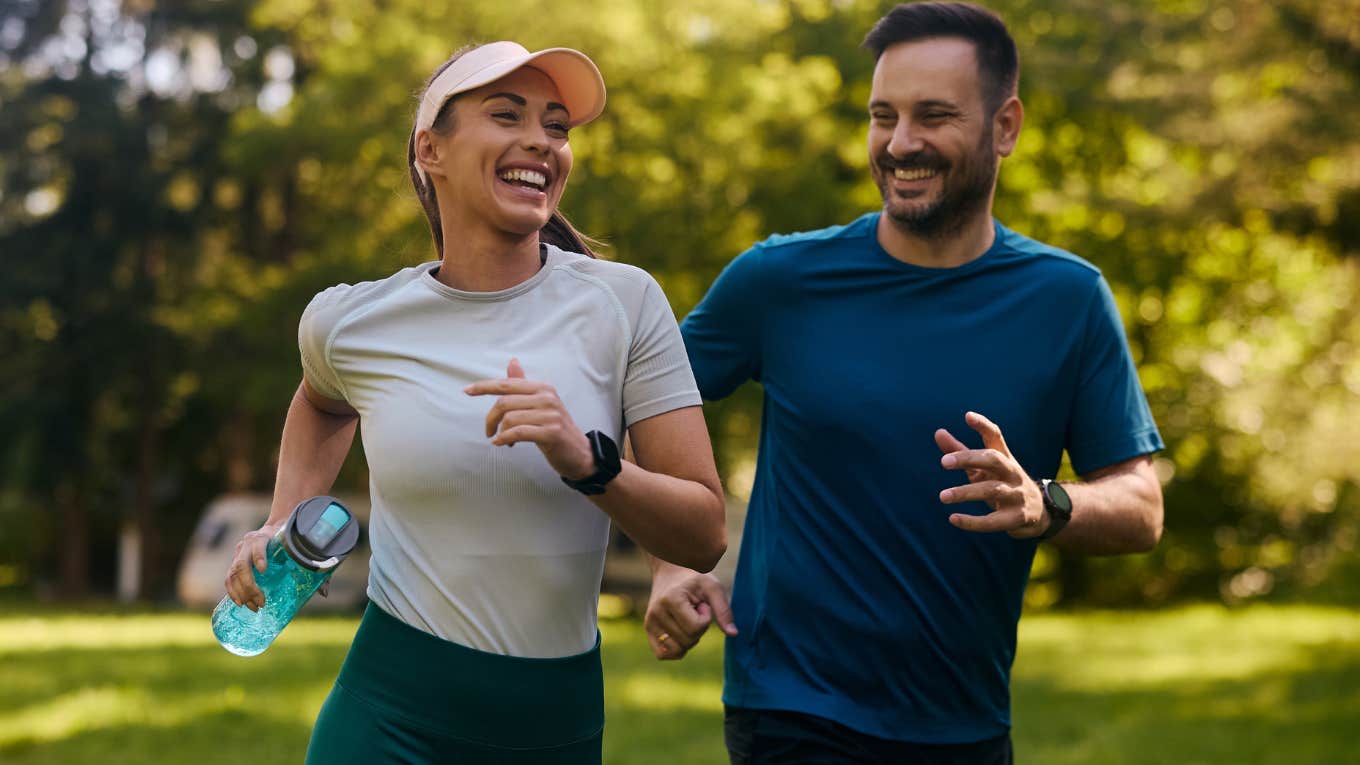 Couple smiling and trying each other's hobbies outside.
