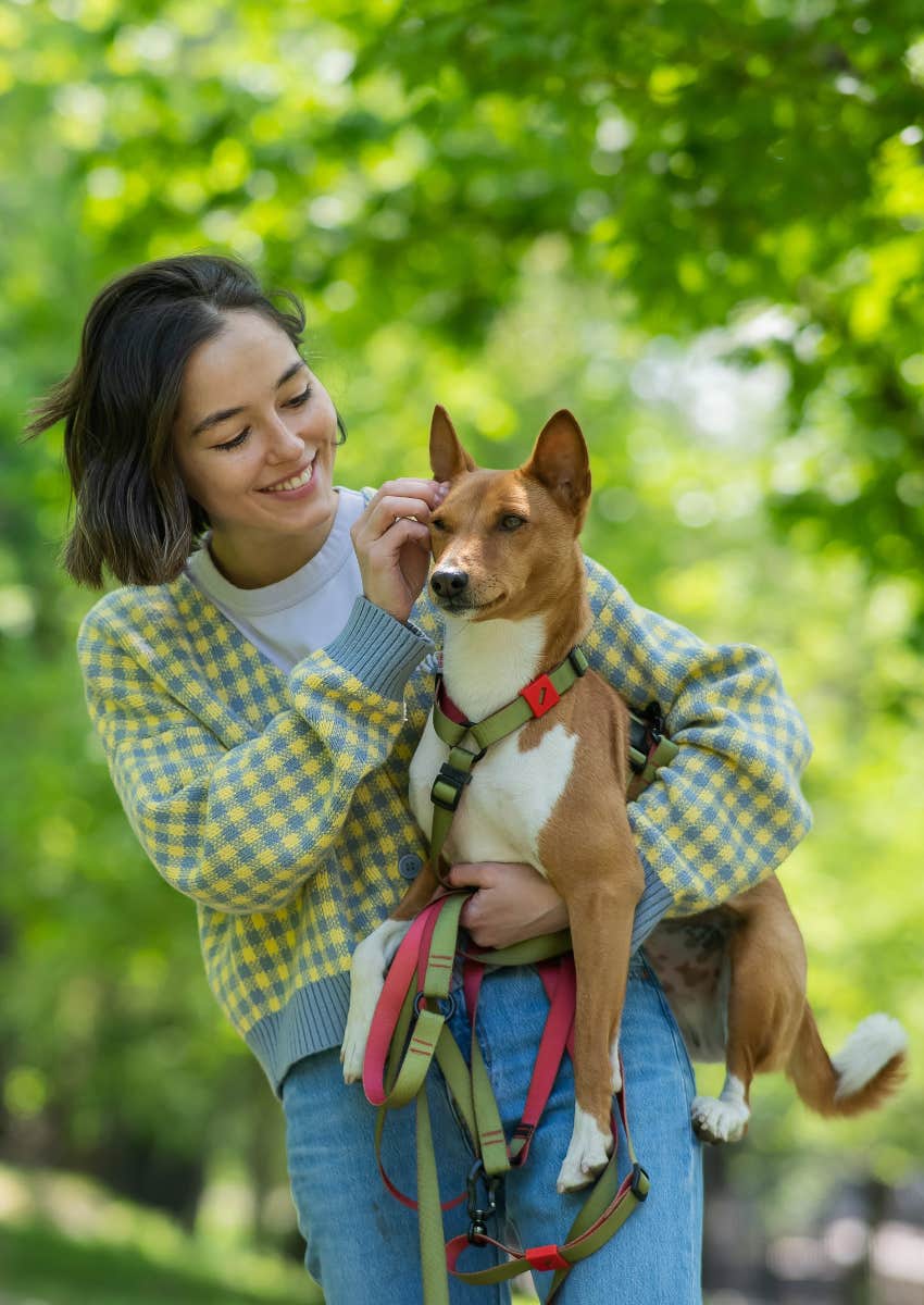 woman caring for her dog like it's her baby