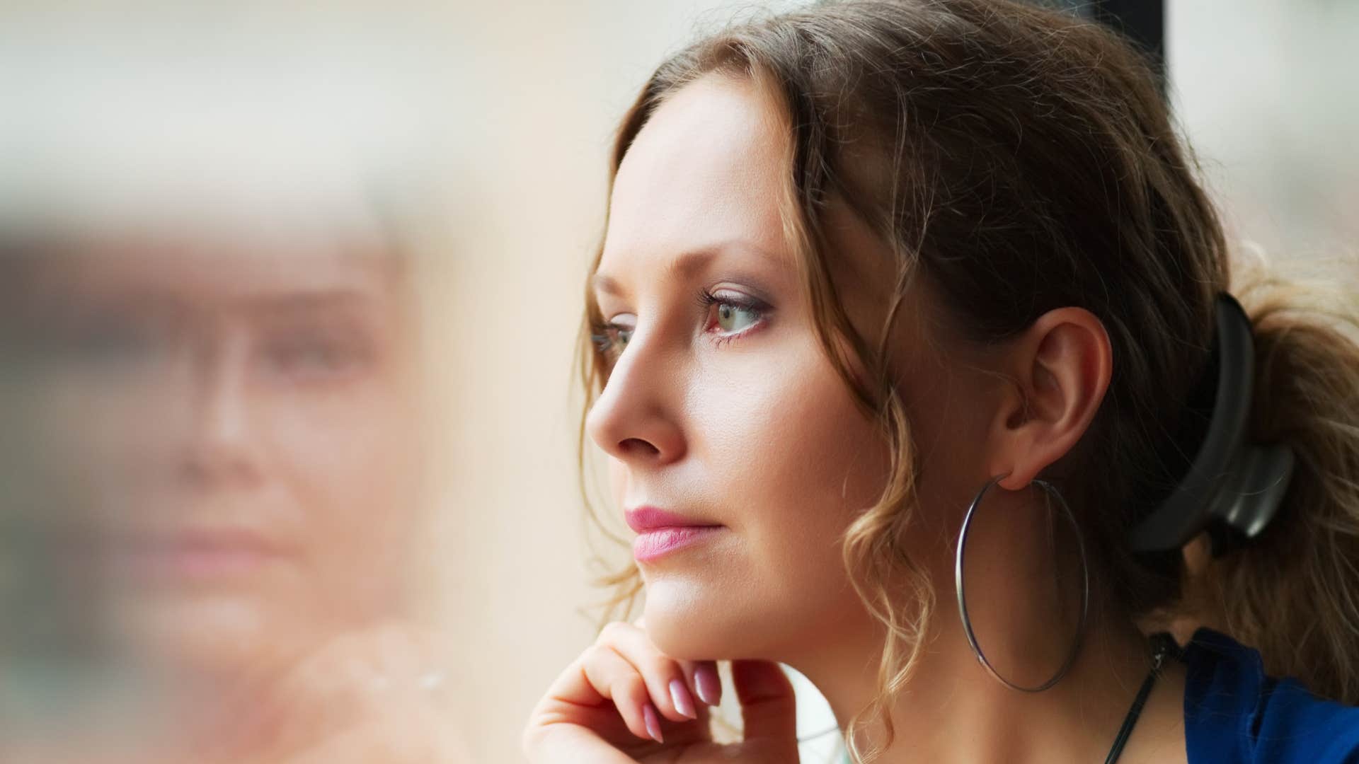woman noticing how she speaks to herself to stop dating losers