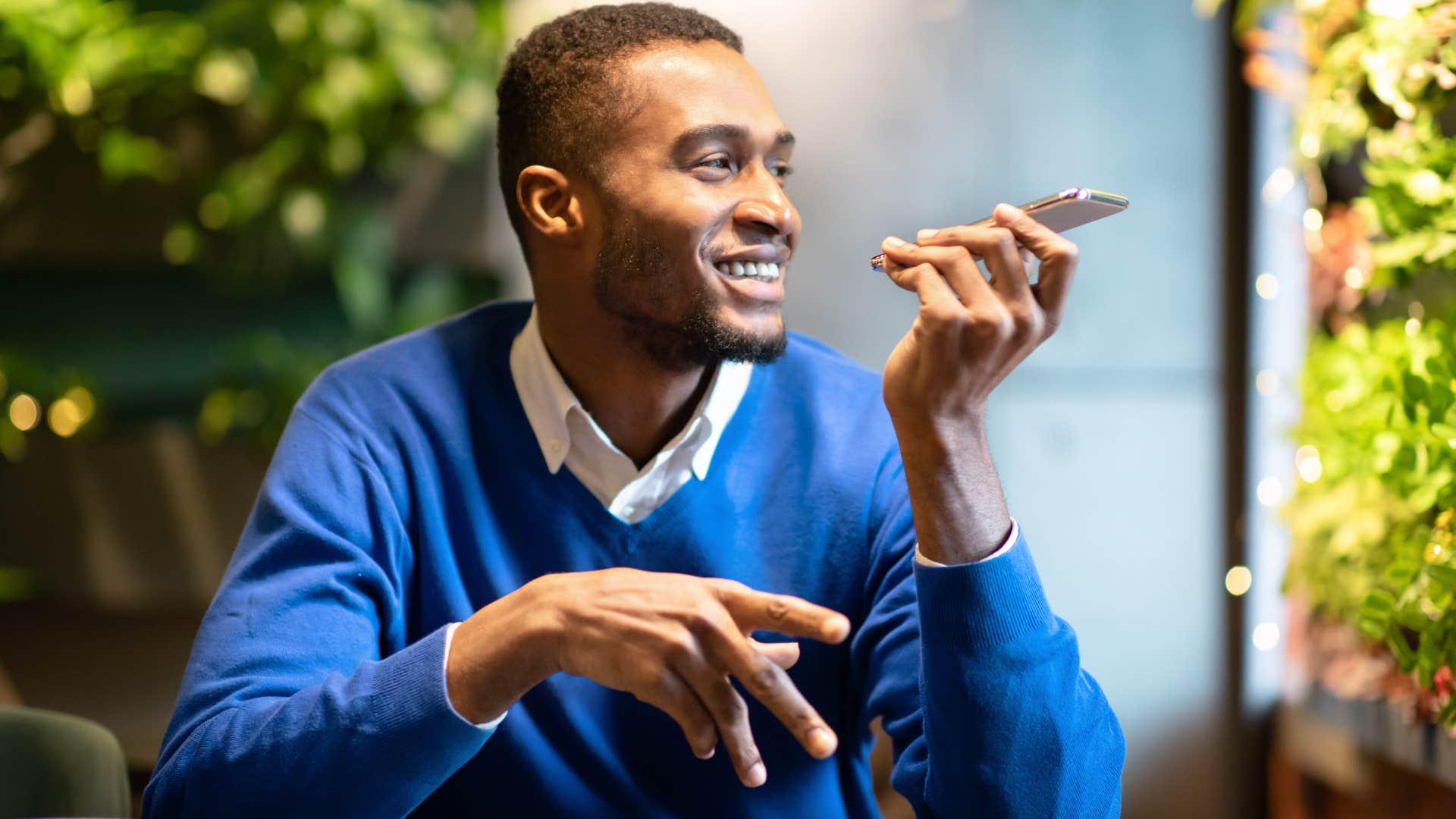 Man talking on speaker phone in public.