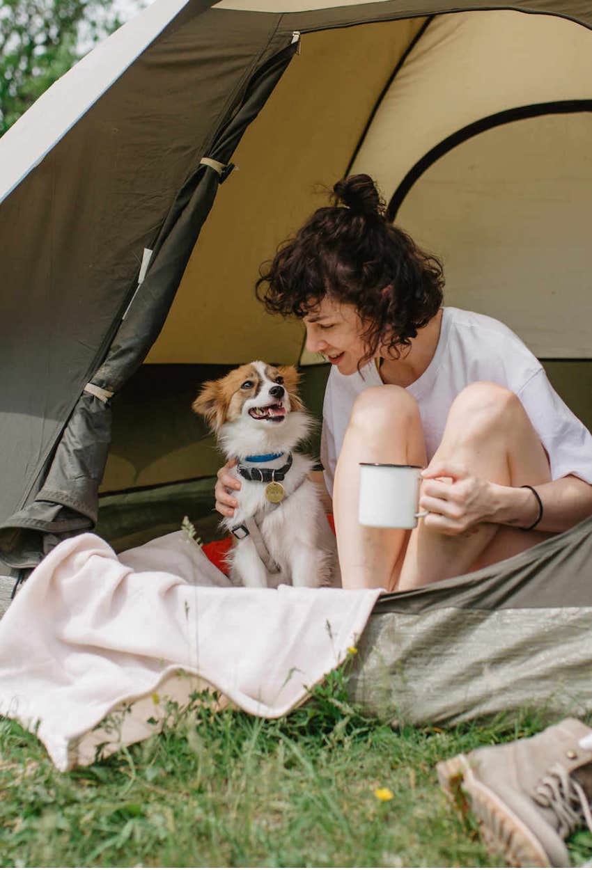 woman camping with her dog
