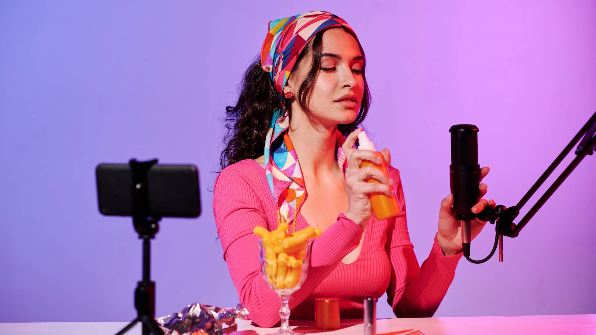 woman recording ASMR content in microphone