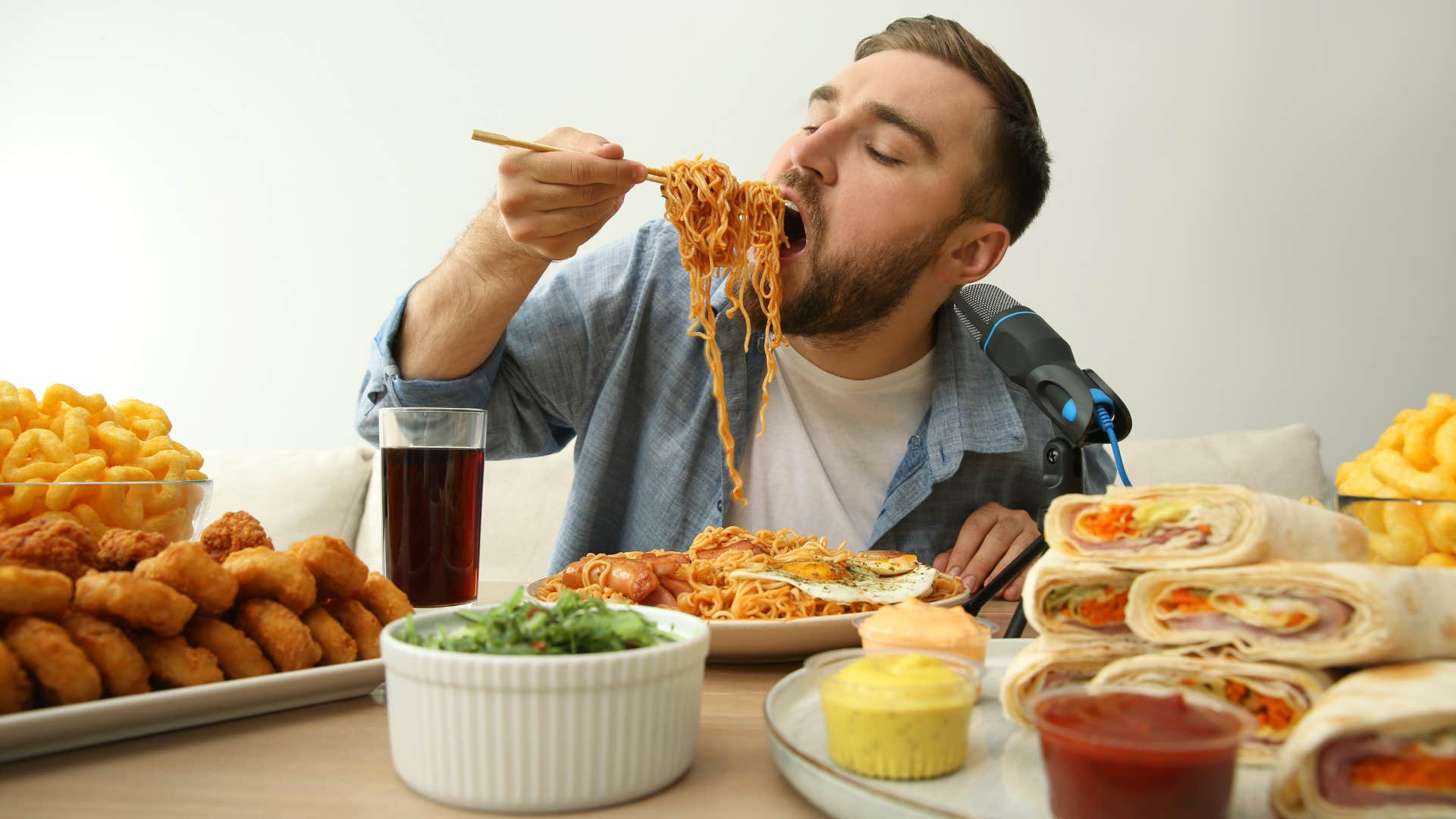 man eating large amounts of food