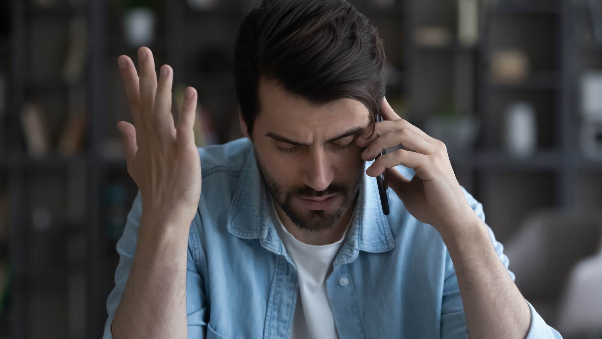 man feeling pressured by his family and friends talking on the phone