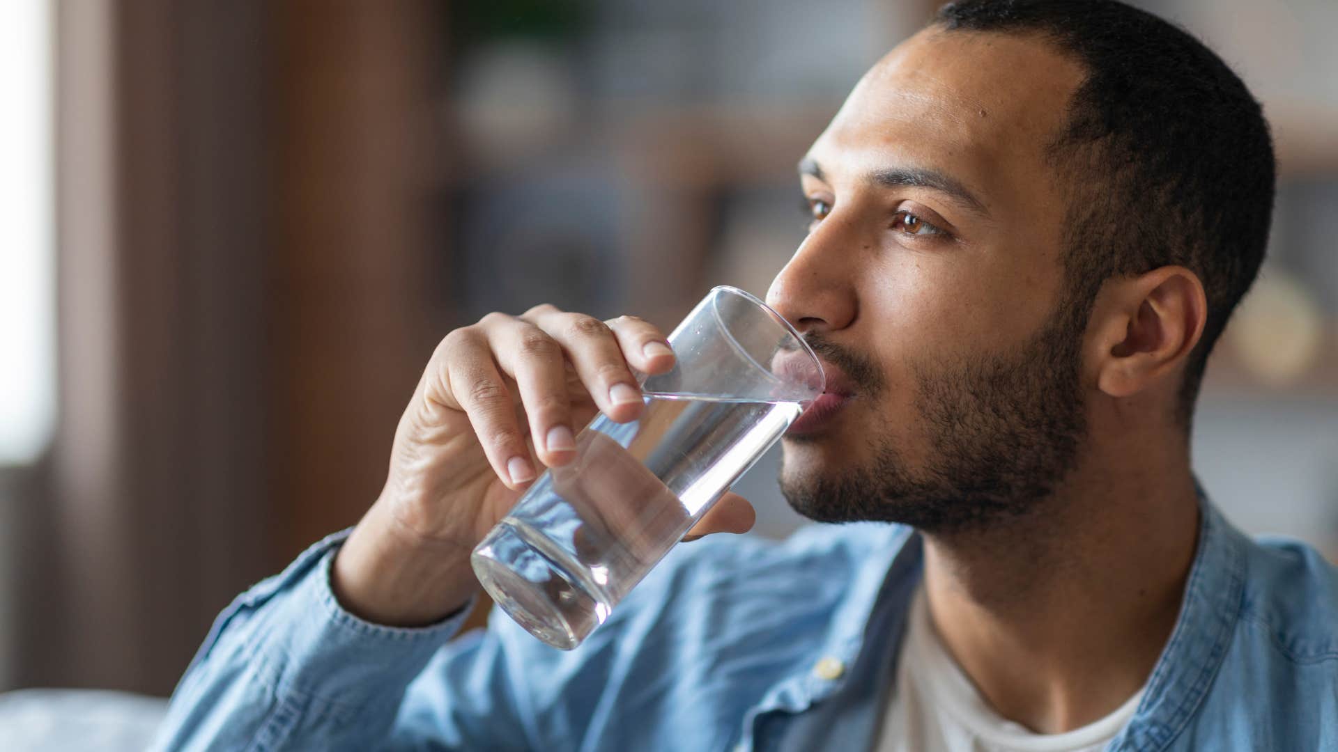 man drinking water because hes dehydrated