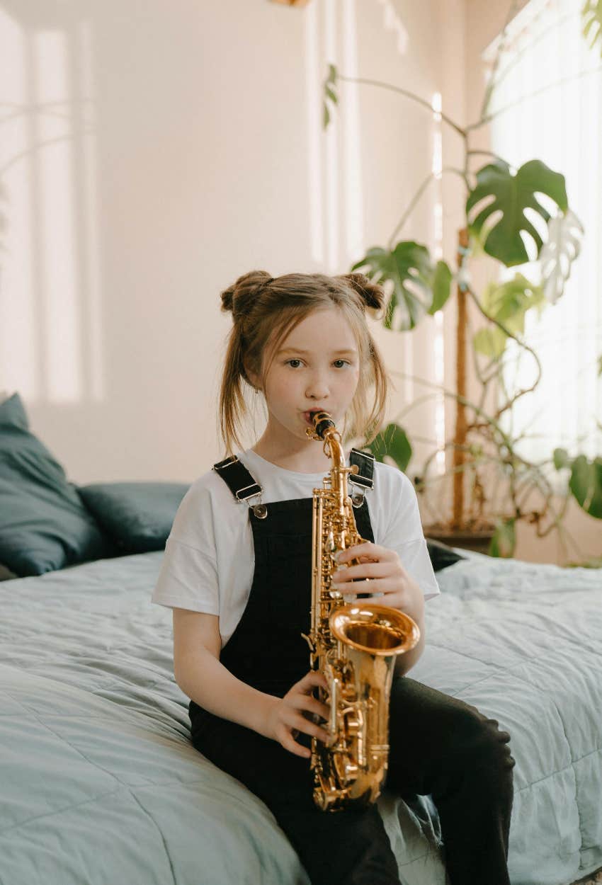 little girl learning the saxophone will end up a successful adult