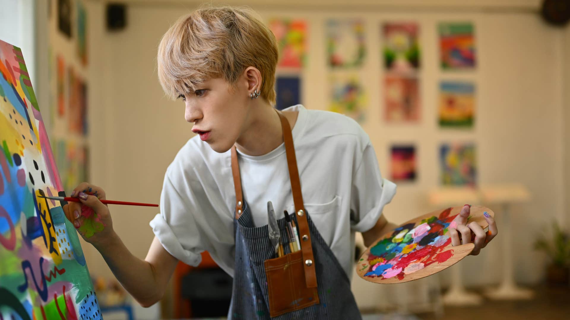 teenage boy creating his purpose painting