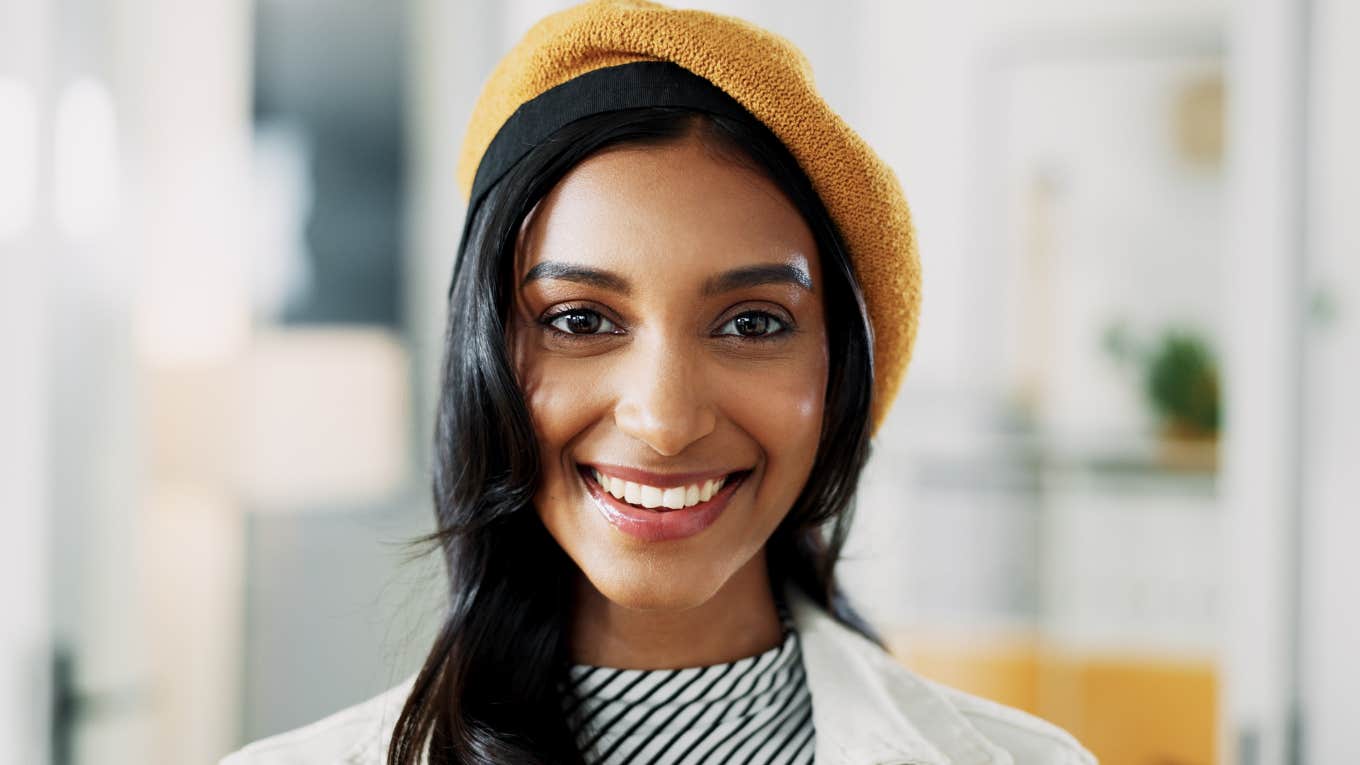 Little Habits That Make Someone Look Way Richer Than They Actually Are smiling woman looking richer than she actually is