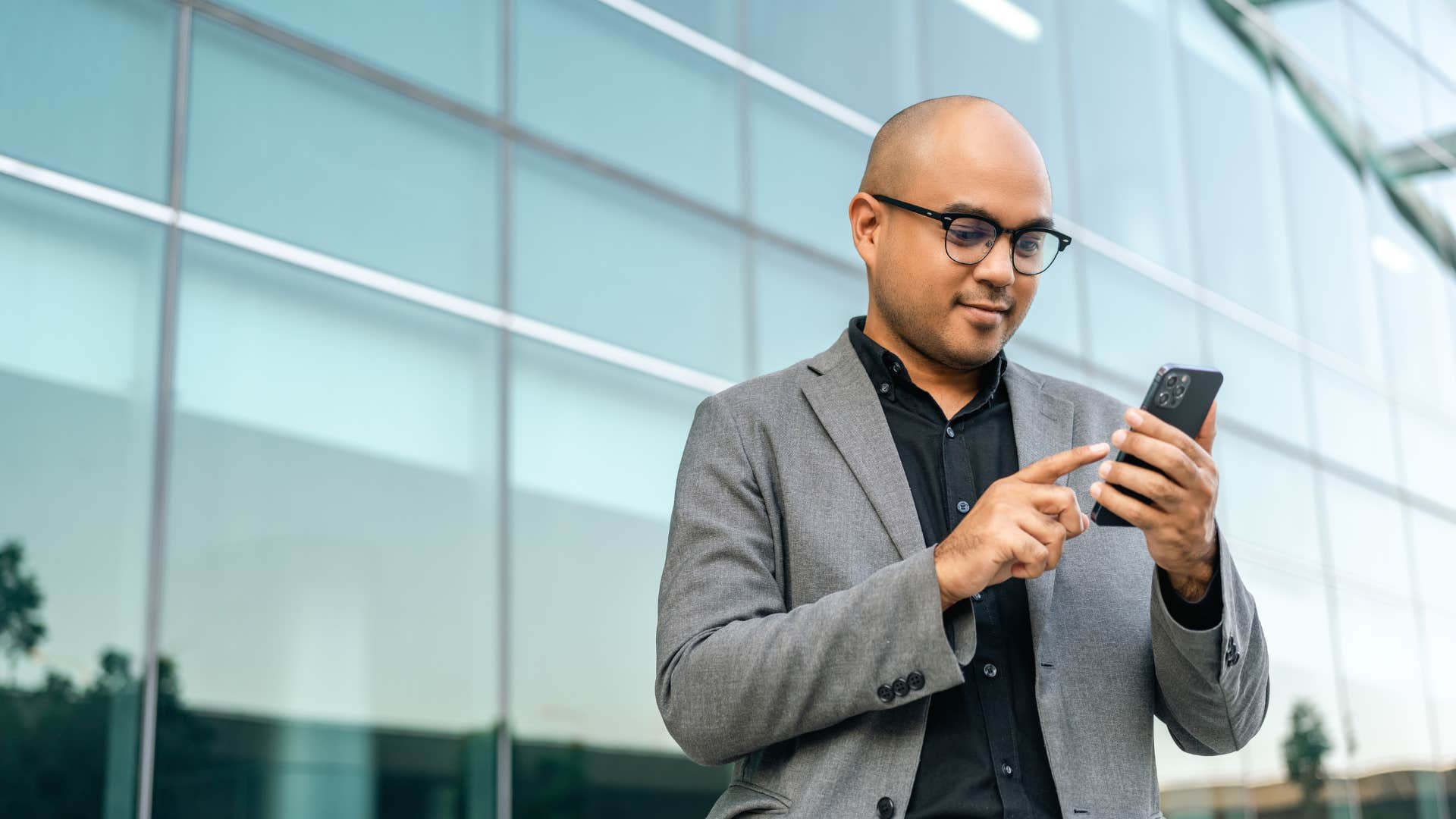 man using phone not oversharing on social media