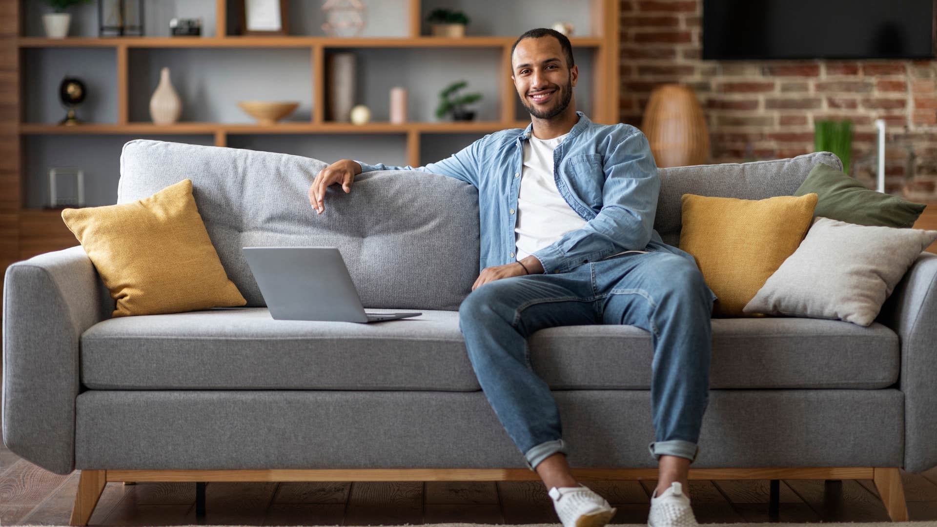 man sitting on couch with good posture