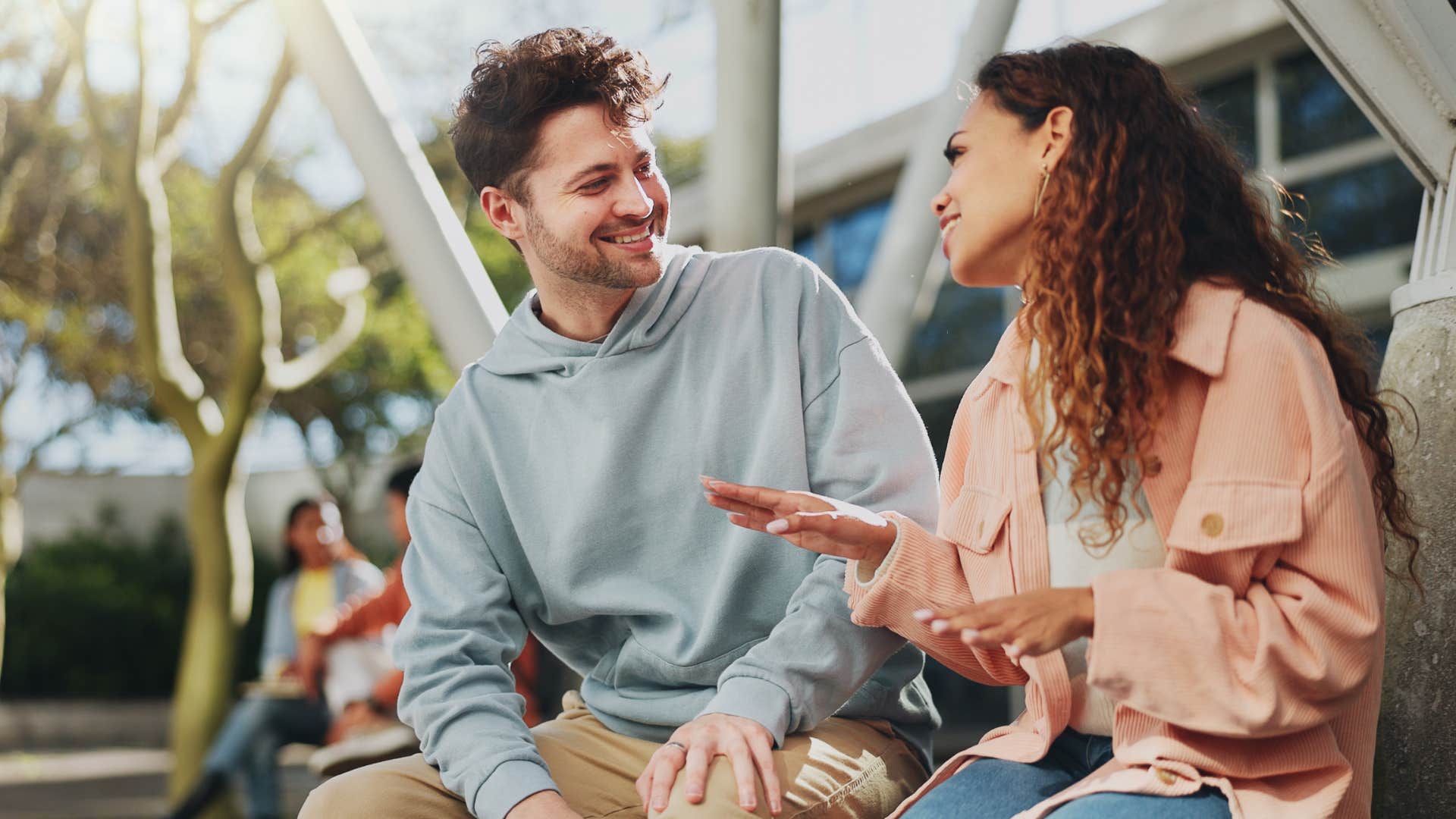 woman speaking clearly and softly with male friend