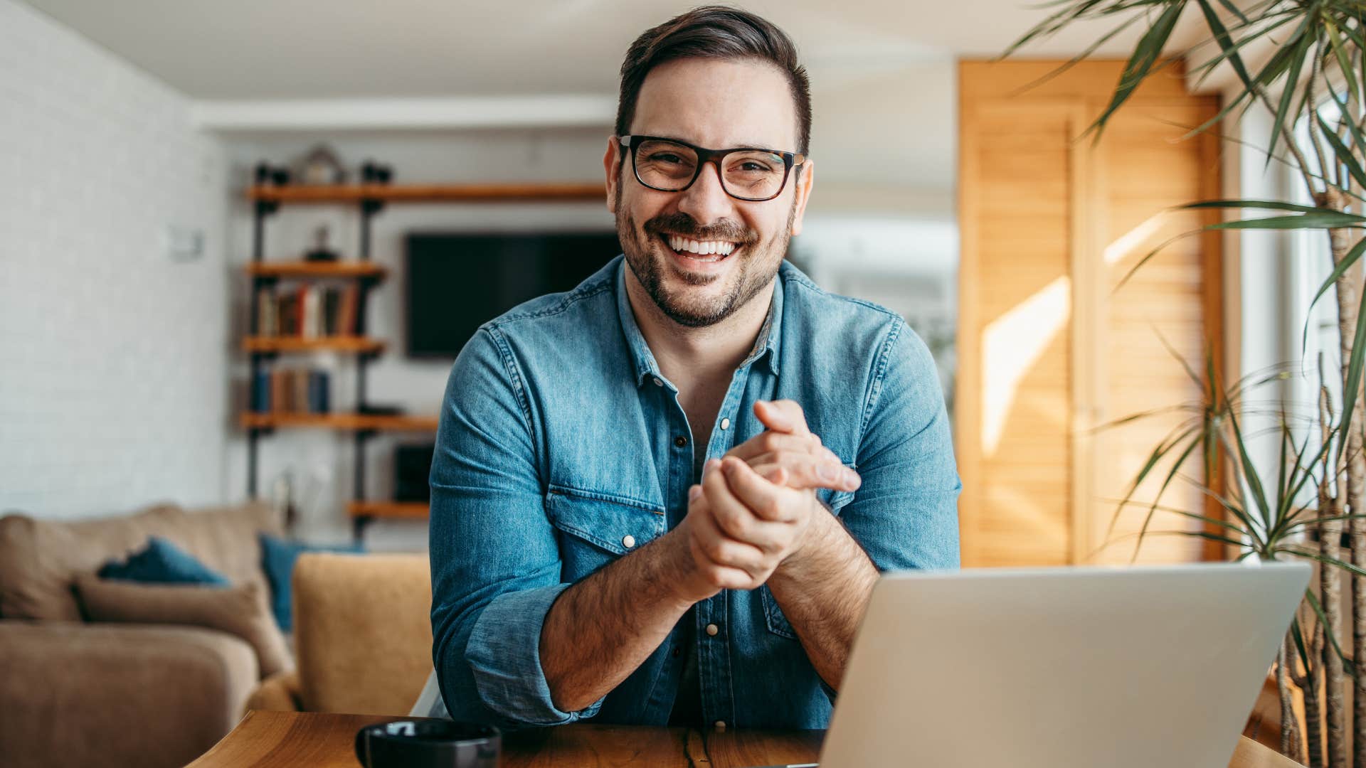 man smiling around his signature colors and decor at home