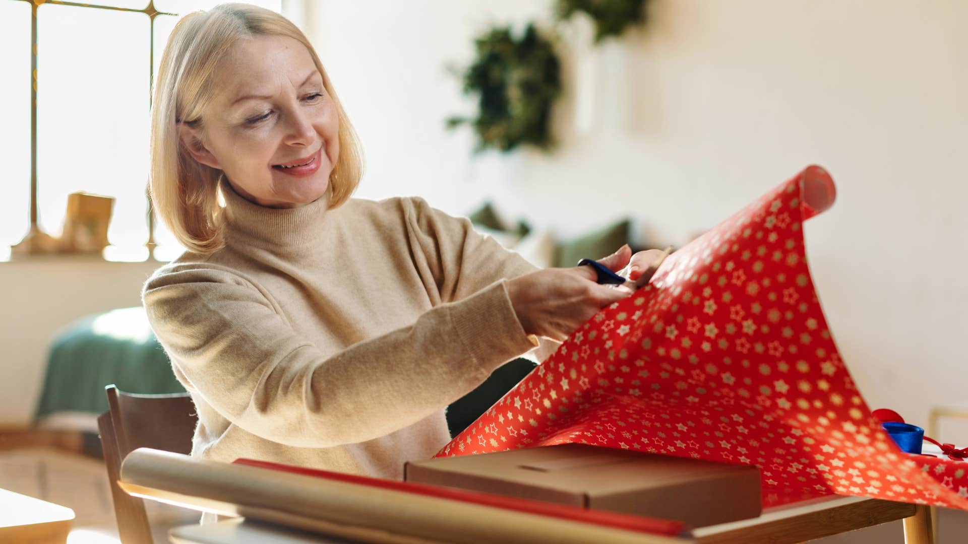 woman using regiftable items and decorations while wrapping a present