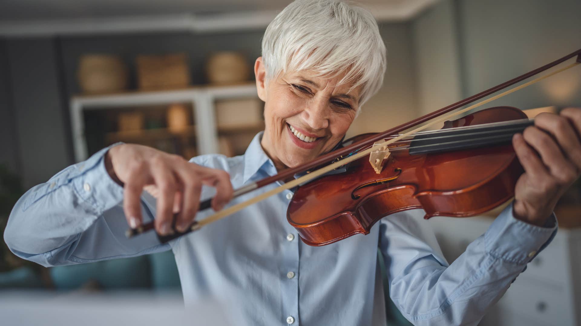 Woman playing musical instruments in her living room.
