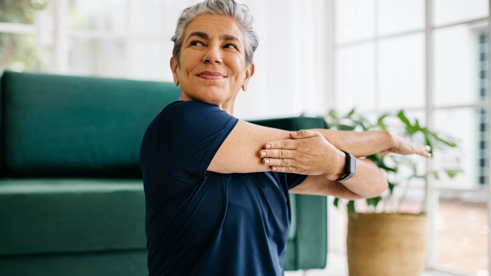 Woman stretching in her place to workout at home.