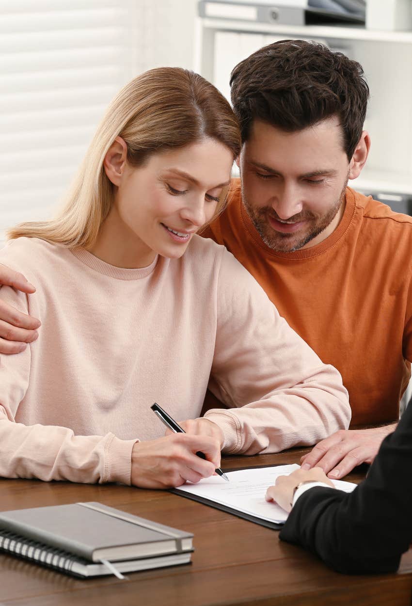 couple signing a prenup even though most men don't want to