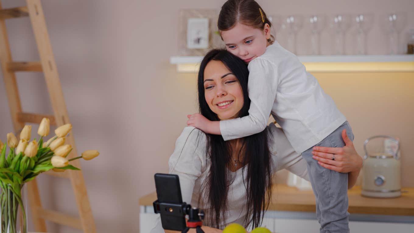 Mom Says Boyfriend Is Limiting Opportunities For Their Kids By Refusing To Make Money Off Them On Social Media mom recording video with daughter
