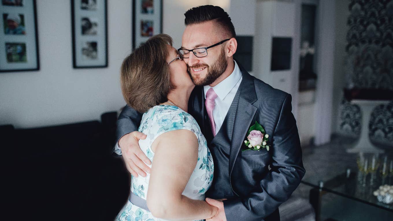 mother of the groom hugging her son
