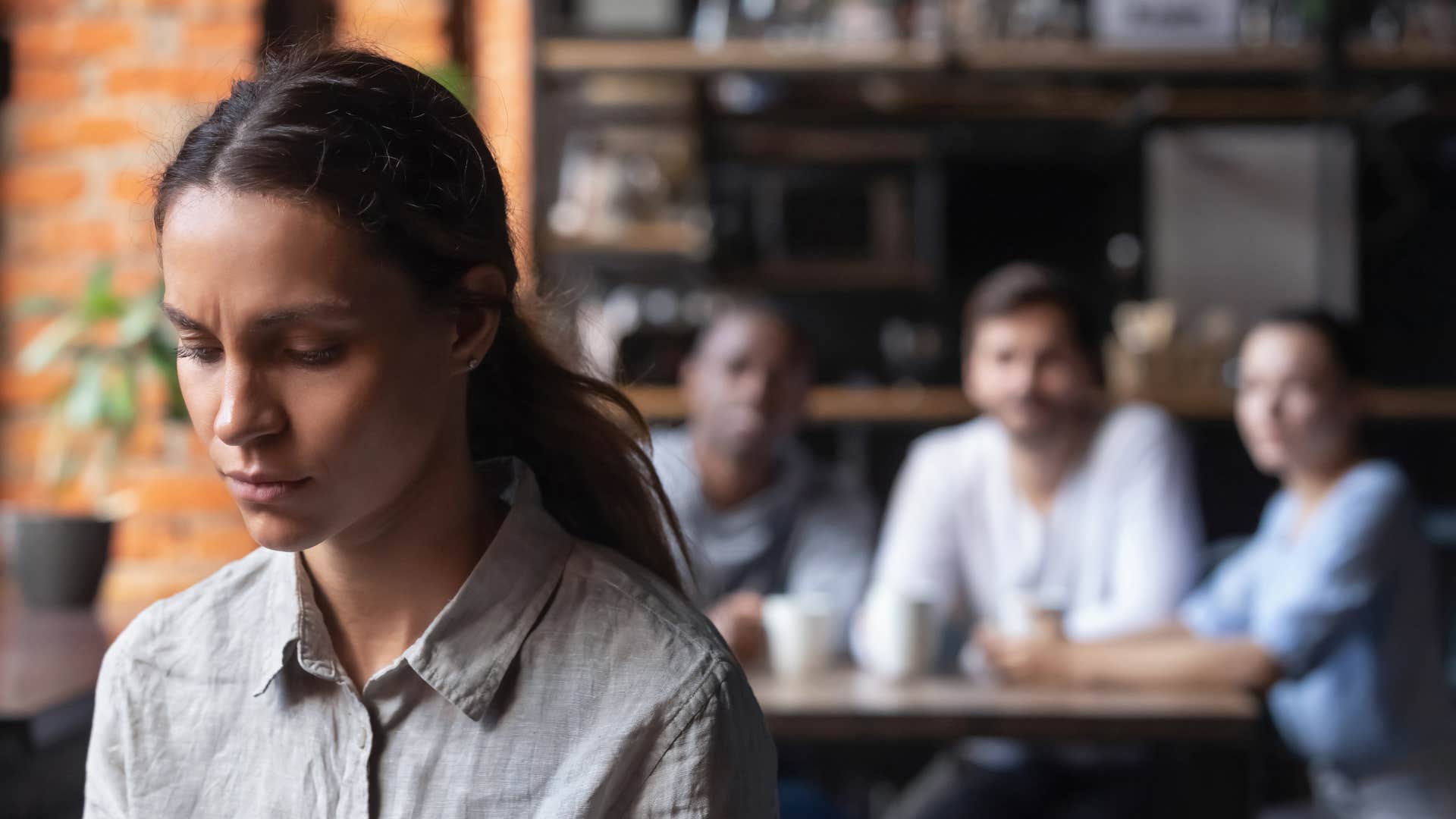 introverted woman at happy hour drinks with coworkers