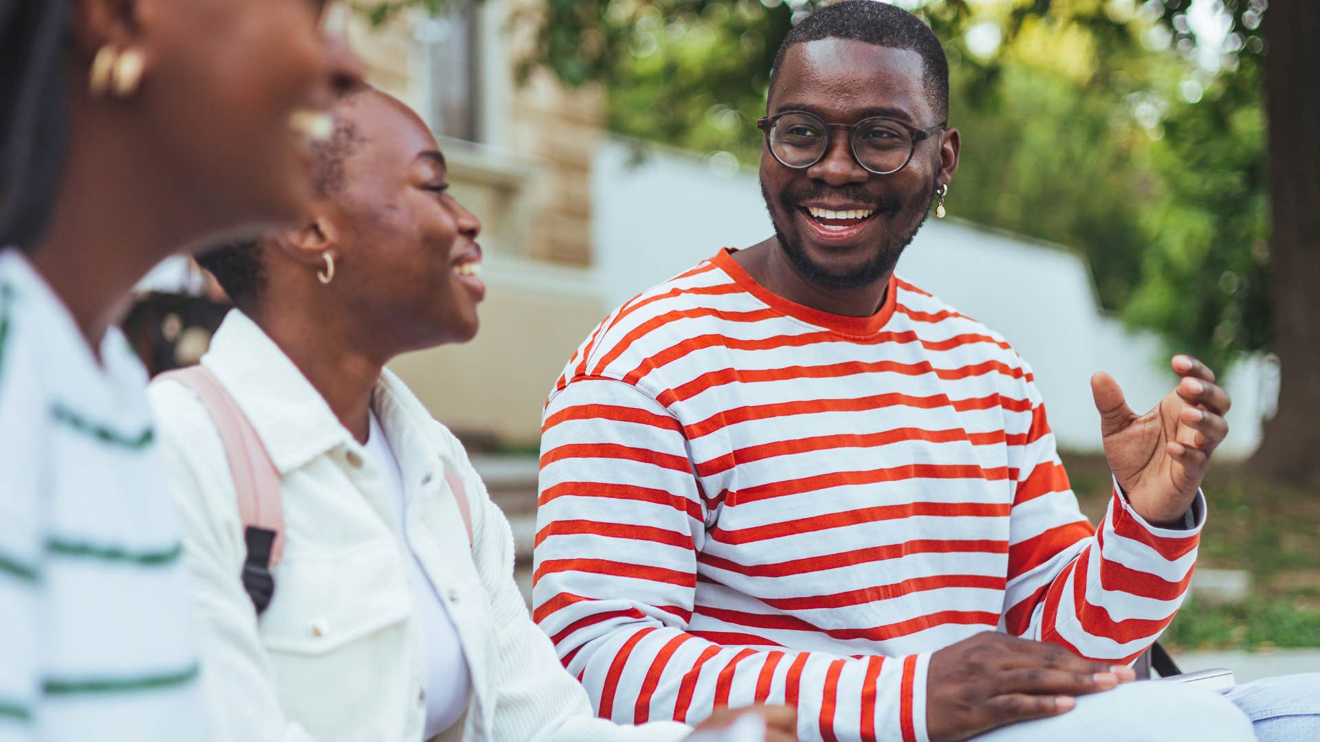 friends smiling and talking about diversity in a city