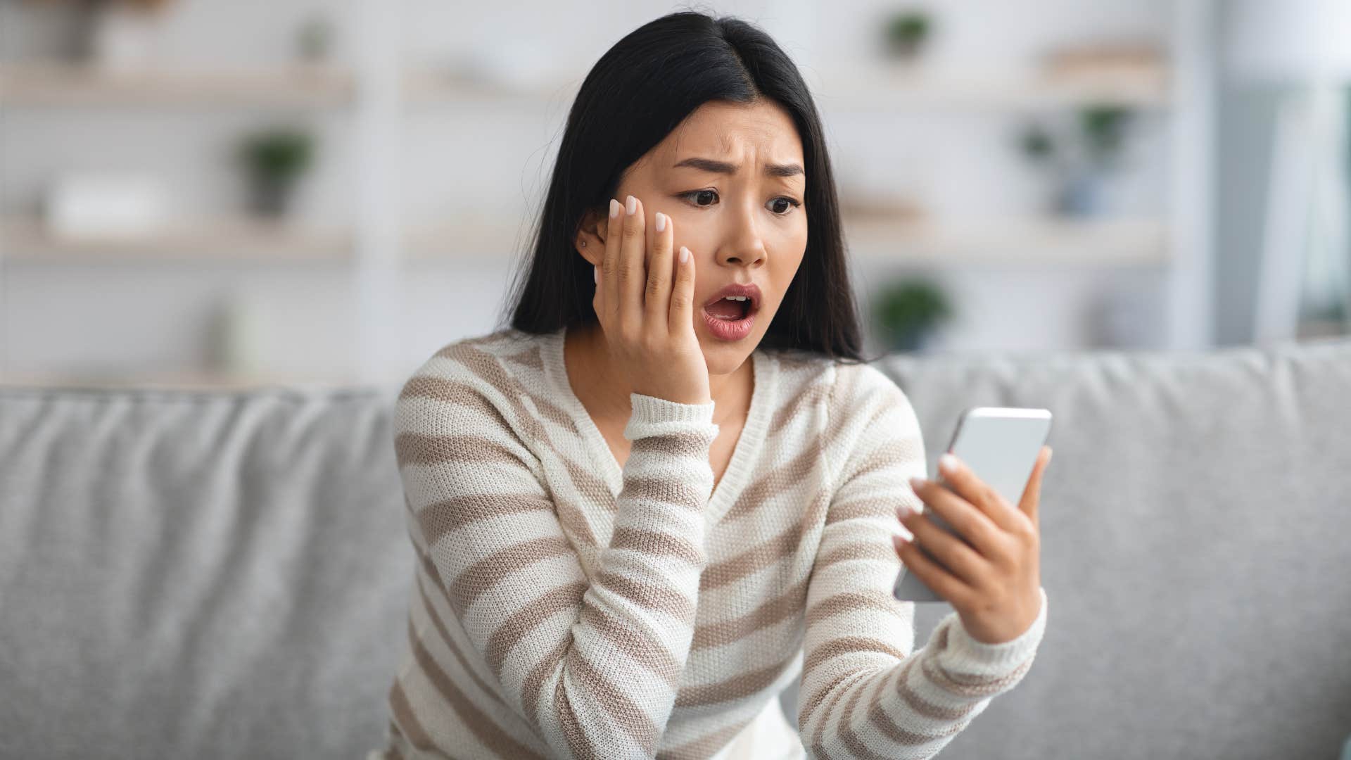 shocked woman looking at housing costs 