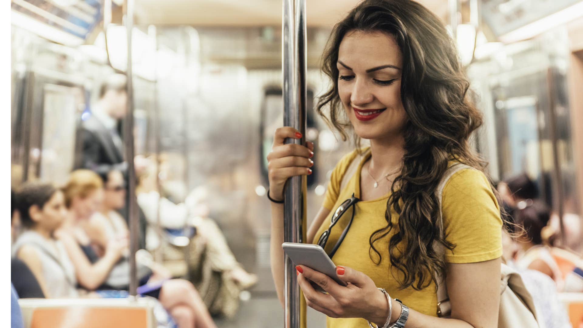 woman blocking out noise on the subway with her phone