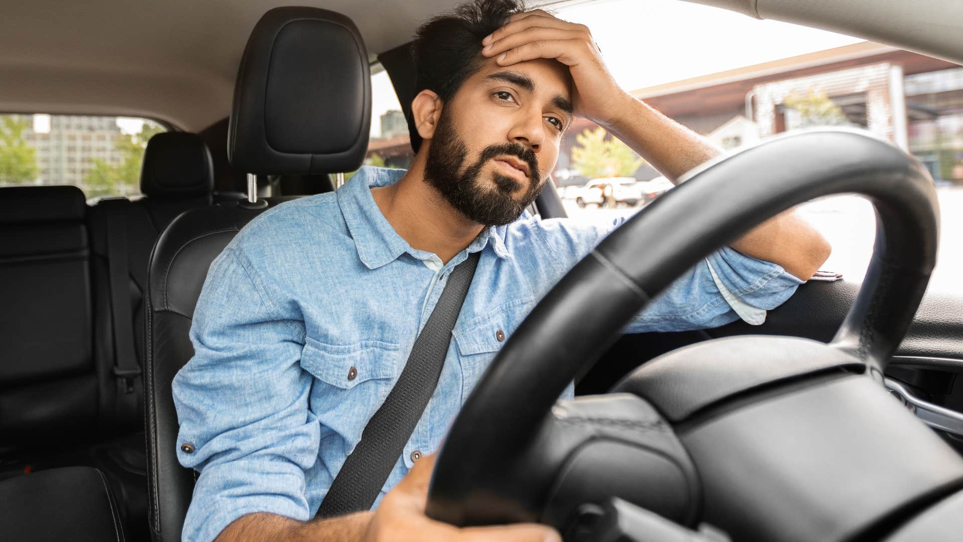 man upset about paying for parking stressed in his car