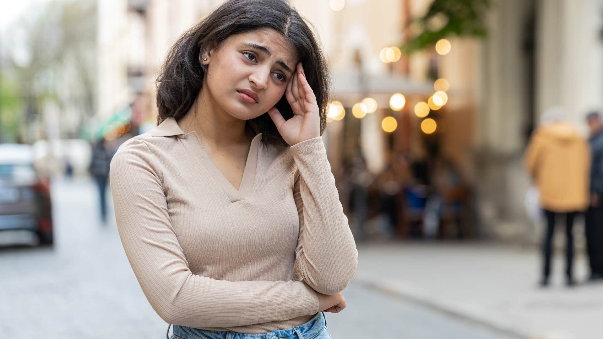 upset woman thinking about no public restrooms in big city